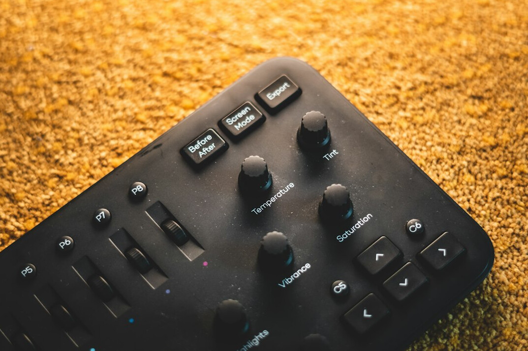 Overhead view of a video switcher control panel with sliders and buttons
